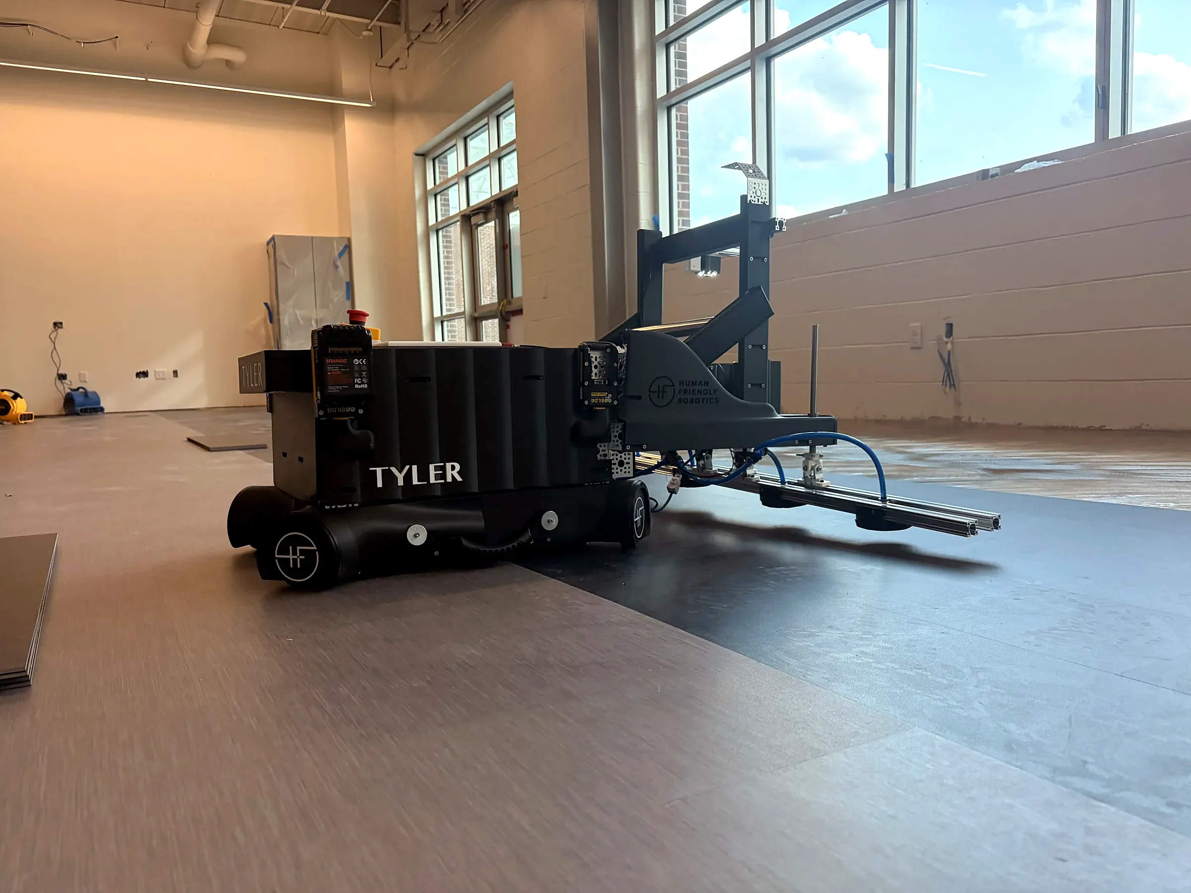 Tyler — tile-setting robot on a commercial jobsite